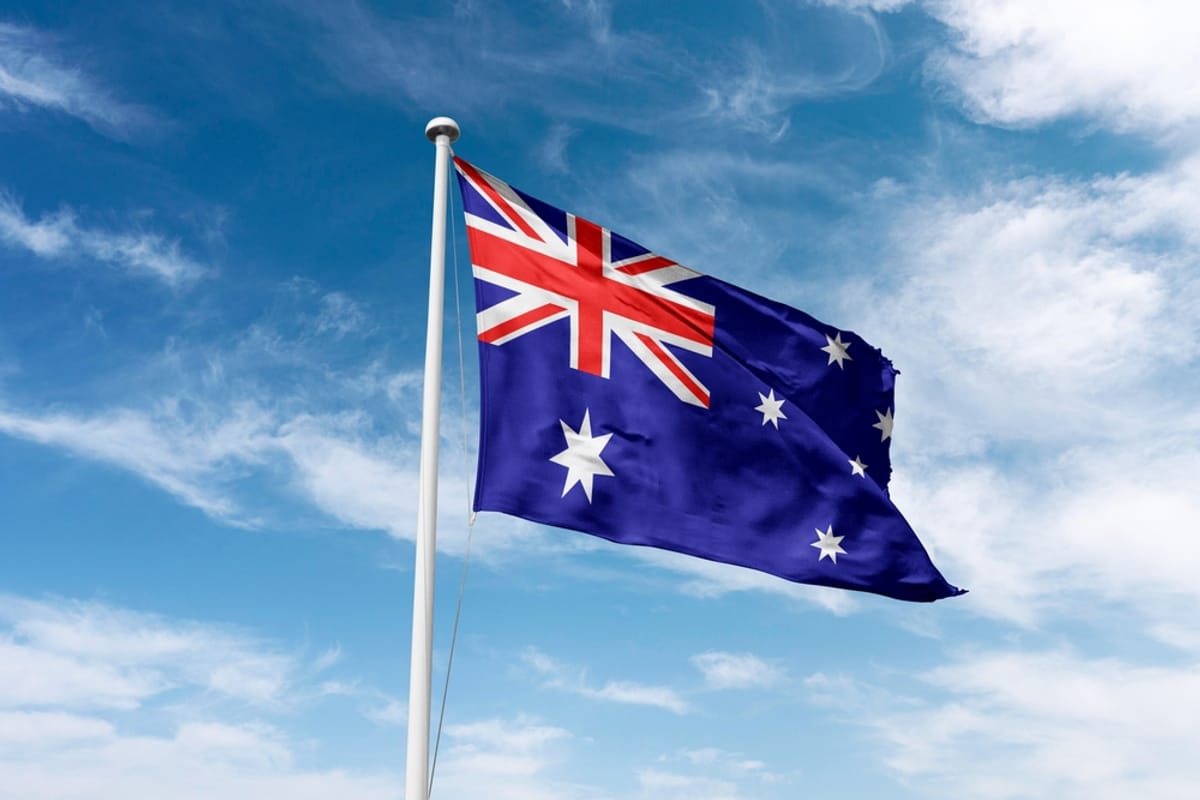 Australian flag waving against a cloudy sky